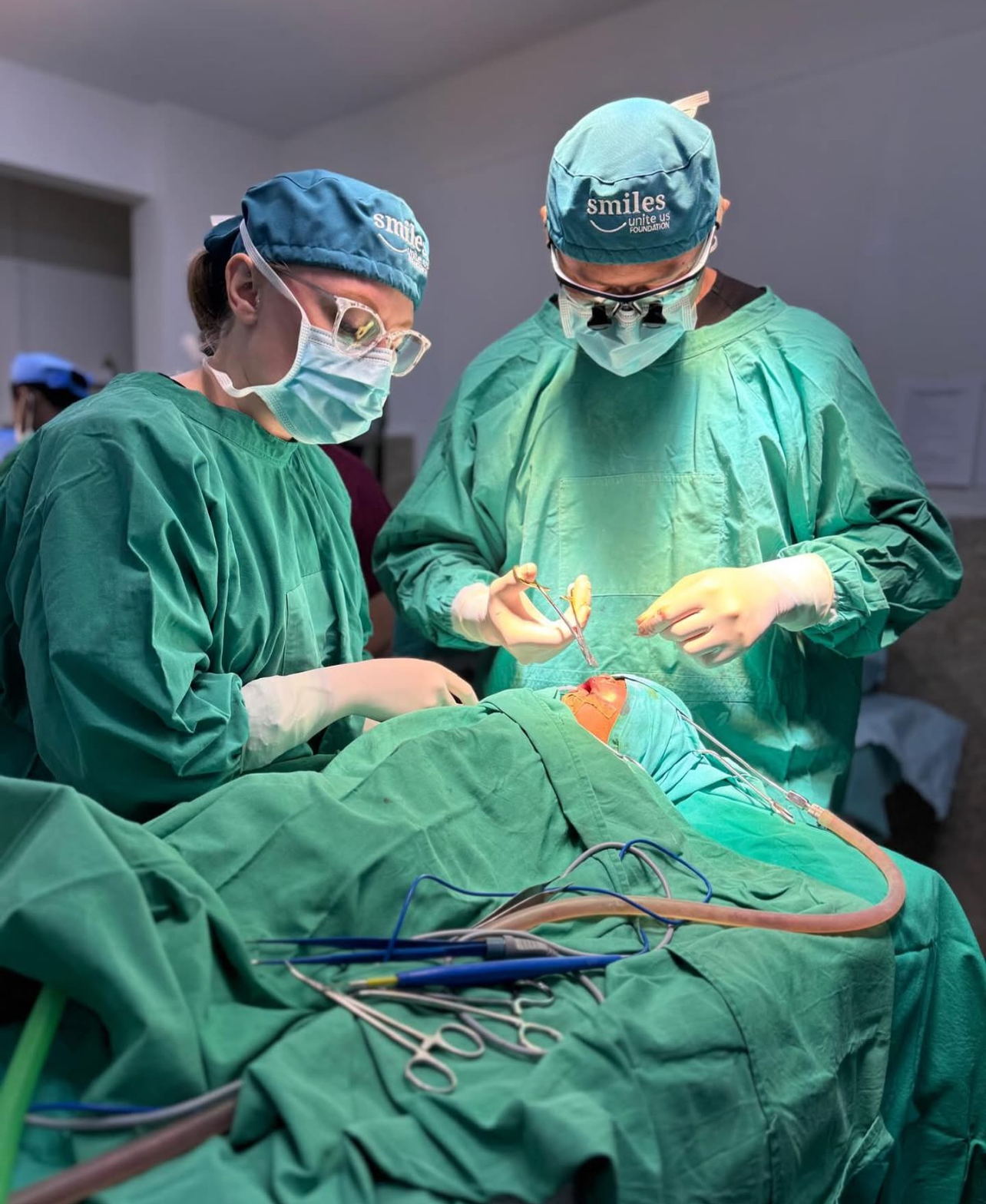 Dr. Khan and surgical partner working with a patient on a mission trip