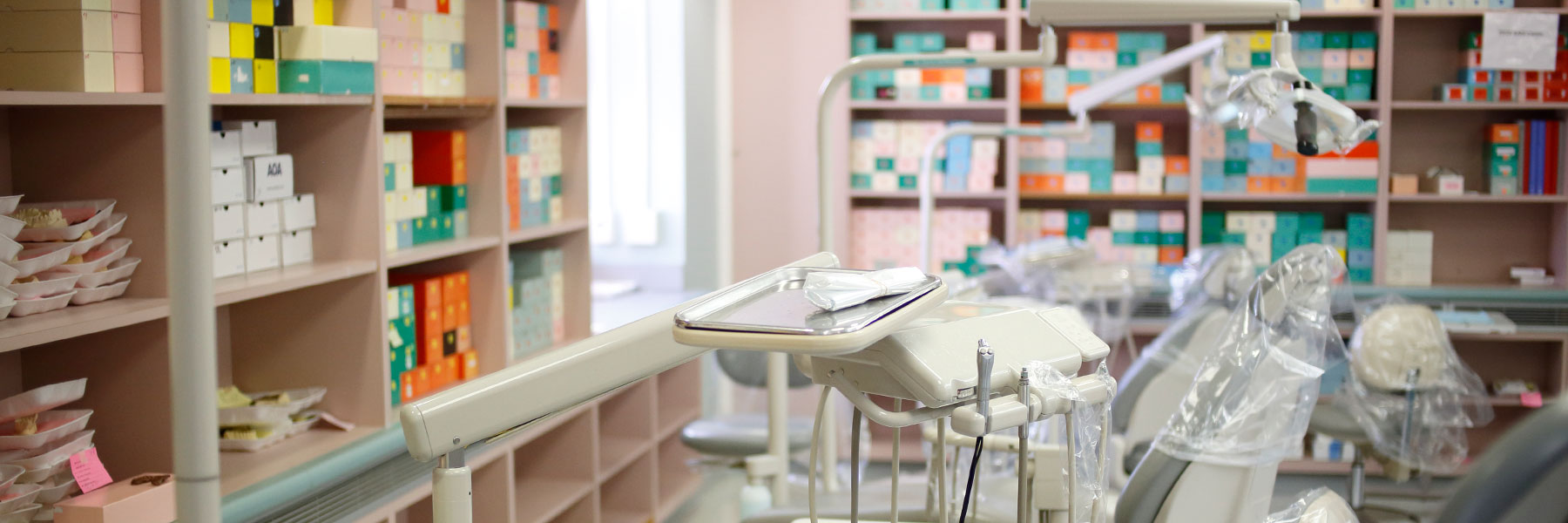 A row of exam chairs and dental equipment in a lab